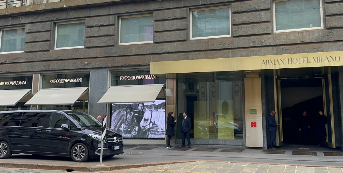 Private chauffeur waiting for passengers at a hotel in Milan before transfer to La Spezia