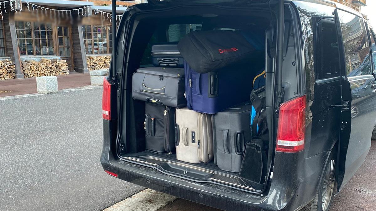 Suitcases, a ski bag and other passenger luggage loaded into the trunk of a Mercedes V-Class for a transfer from Geneva airport to Chamonix