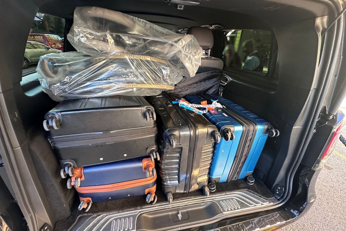 Suitcases and strollers loaded into the trunk of a Mercedes V-Class for a transfer from Nice Airport