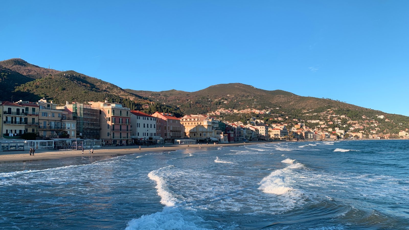 Alassio in northern Italy with mountains and waterfront buildings
