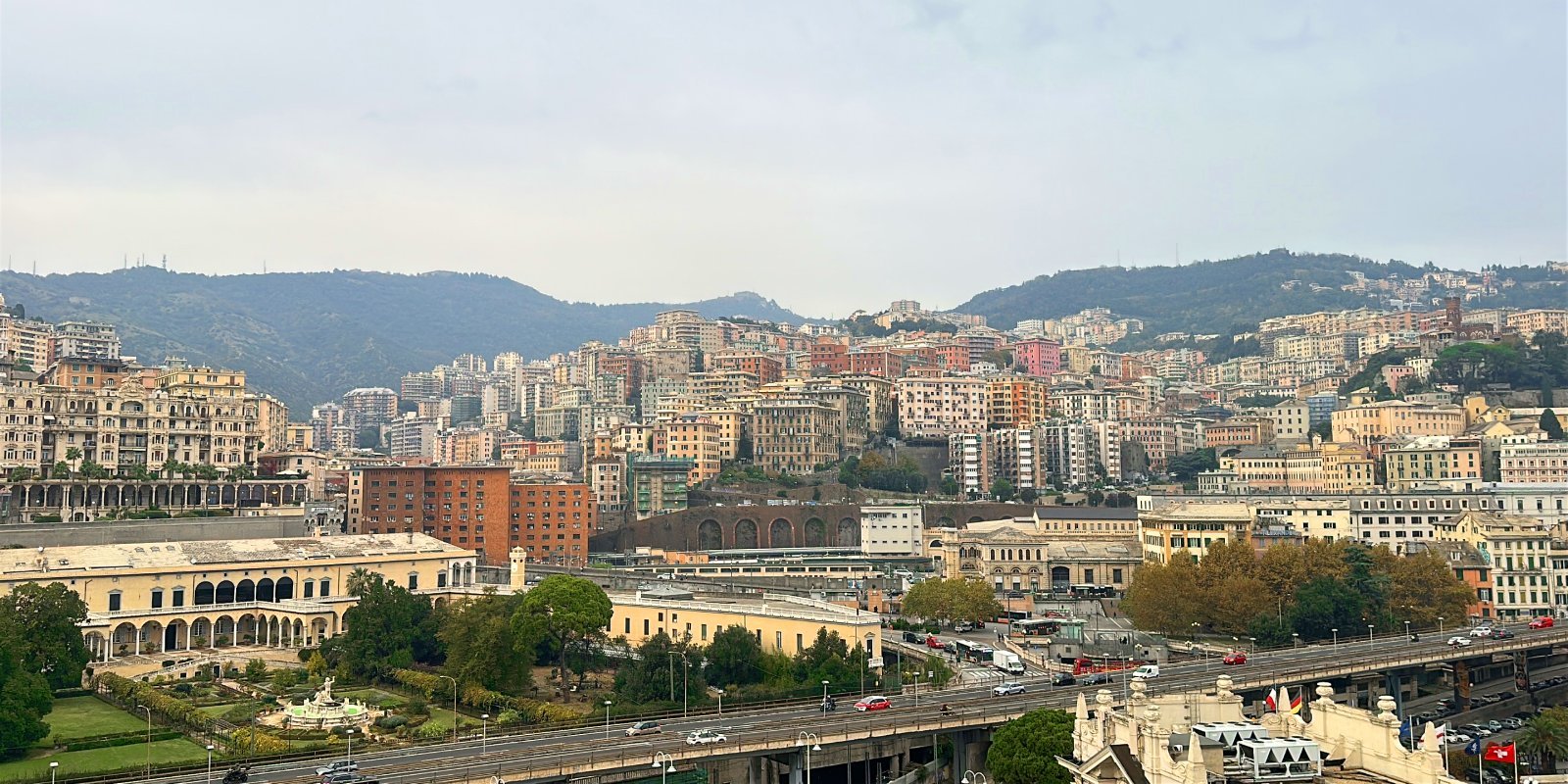 Genoa in northern Italy with mountains and waterfront buildings