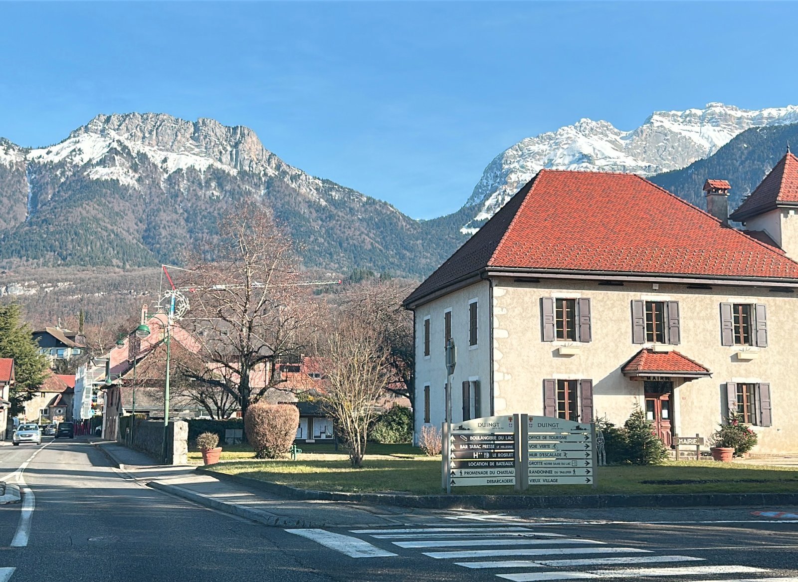 Mountain road near Annecy lake from Geneva Airport to Courchevel in winter by private chauffeur