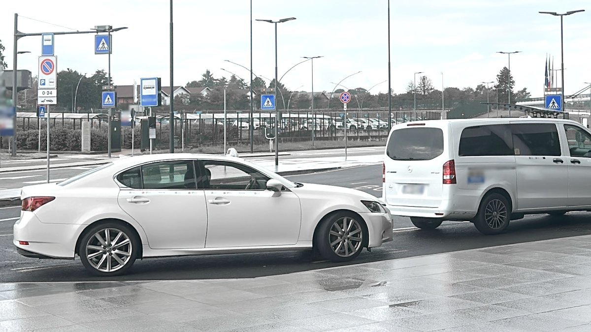 Official taxi waits for passengers to take them from Linate Airport to Madonna di Campiglio