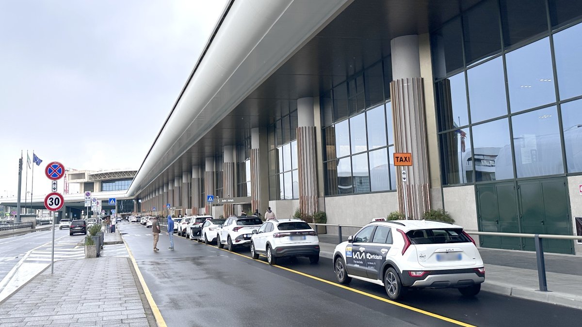 Official taxi waits for passengers to take them from Malpensa Airport to St. Moritz
