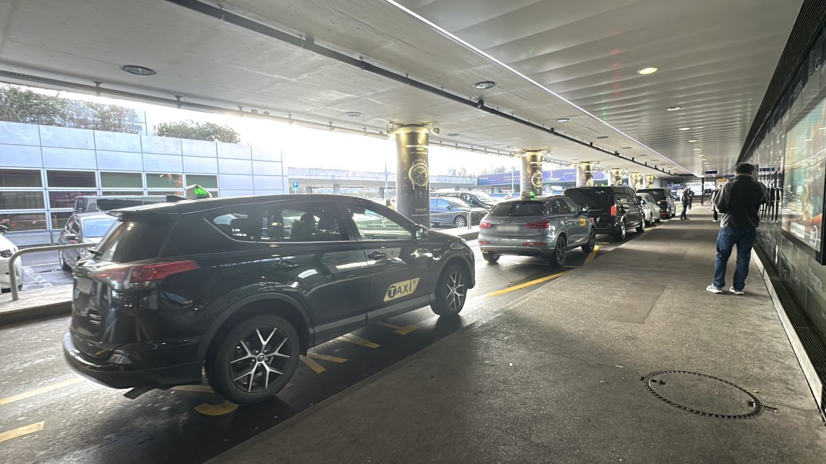 Official taxi is waiting for passengers to take them from Geneva airport to La Plagne