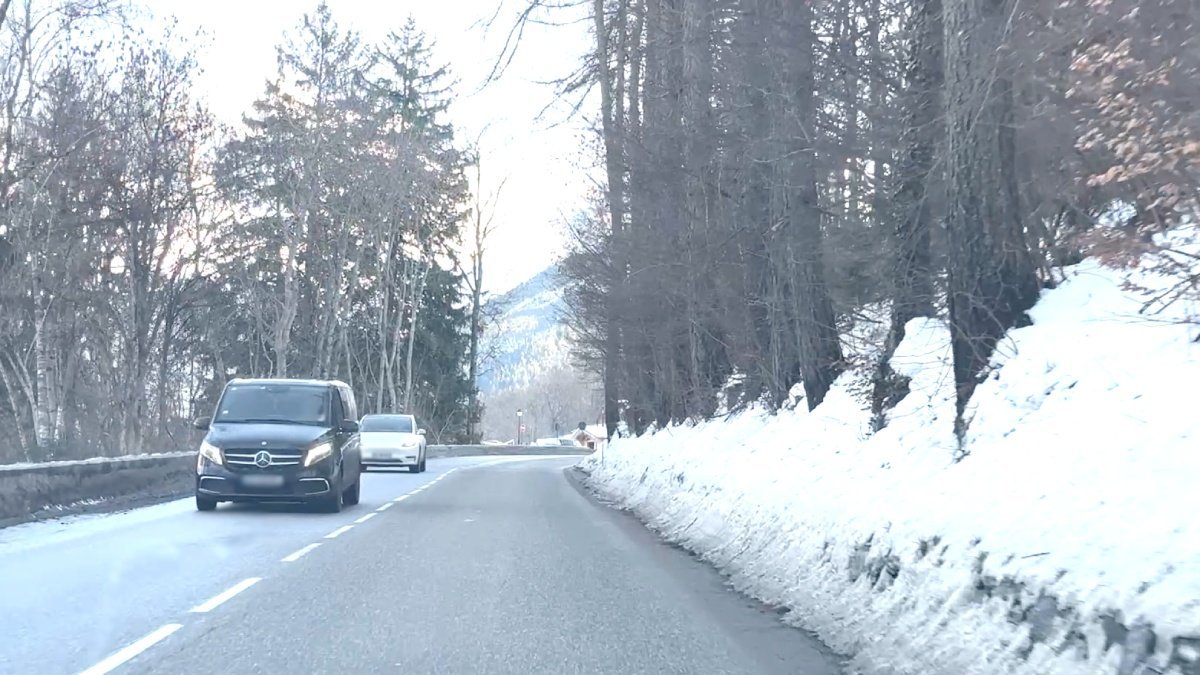 Car performing a transfer on the road to ski resort