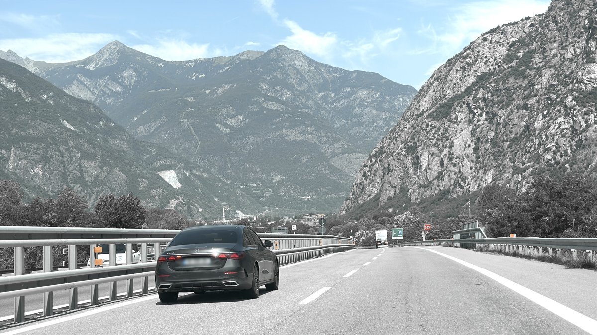 Car performs a transfer on the road from Bergamo Airport to Cervinia